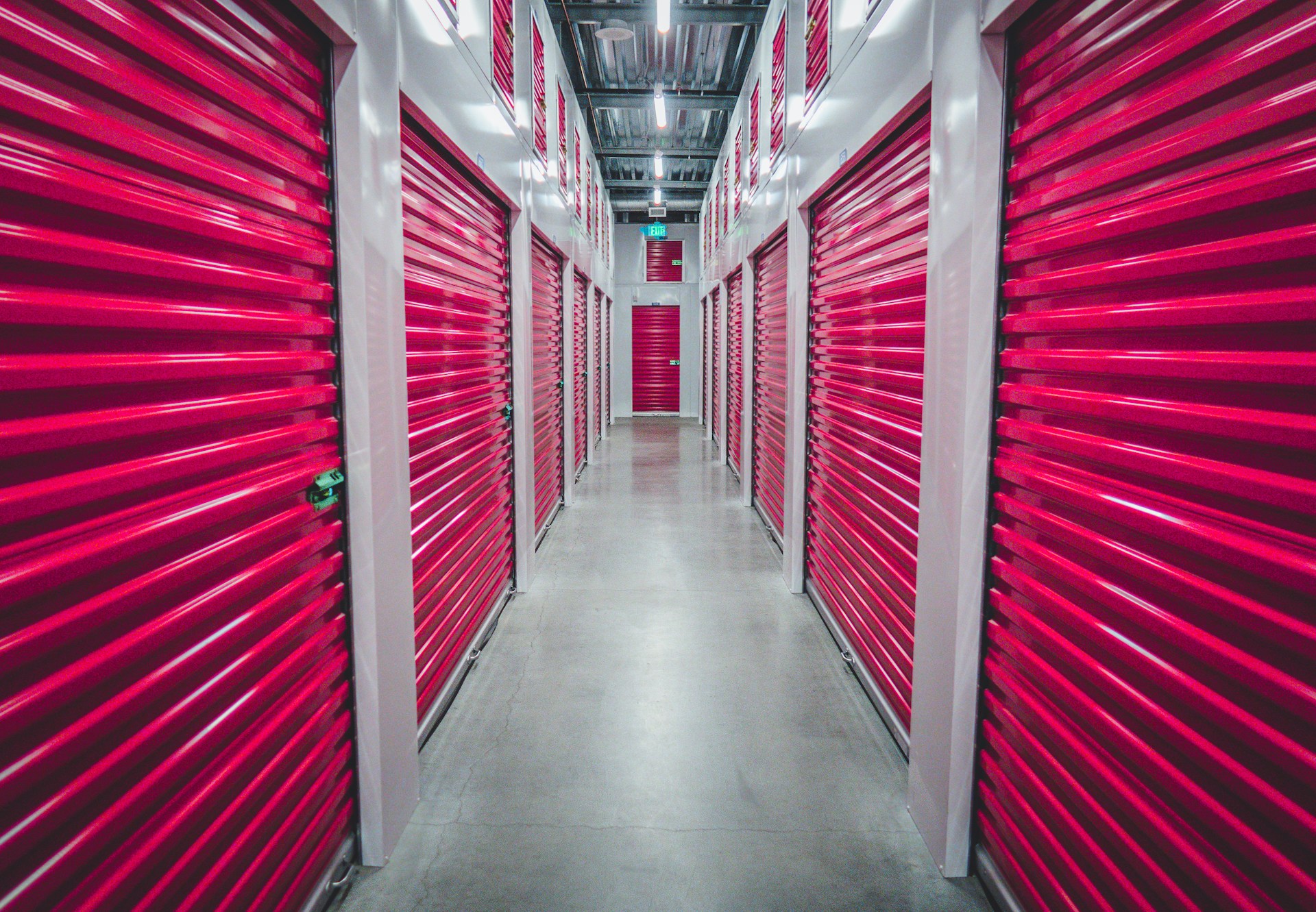 red shutter doors in storage unit hallway