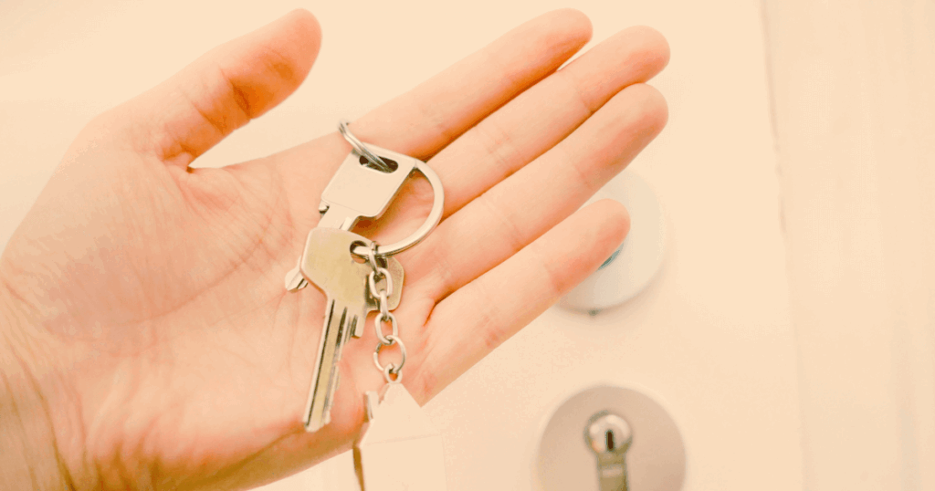 A homeowner holding a key at their front door