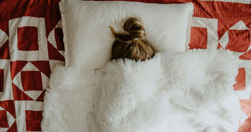 A woman sleeping and cultivating better sleeping habits to combat SAD.