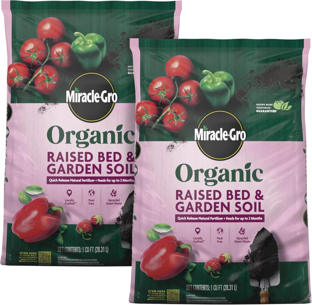 Two green and pink bags of Miracle-Gro's organic raised bed and garden soil sit against a white background.