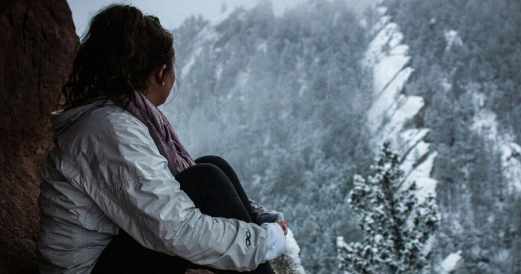 A woman out in nature during winter to combat seasonal affective disorder or winter blues.