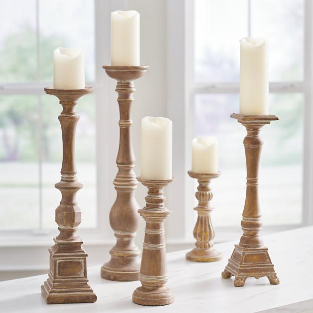 tall vintage-looking candle stands in different heights
