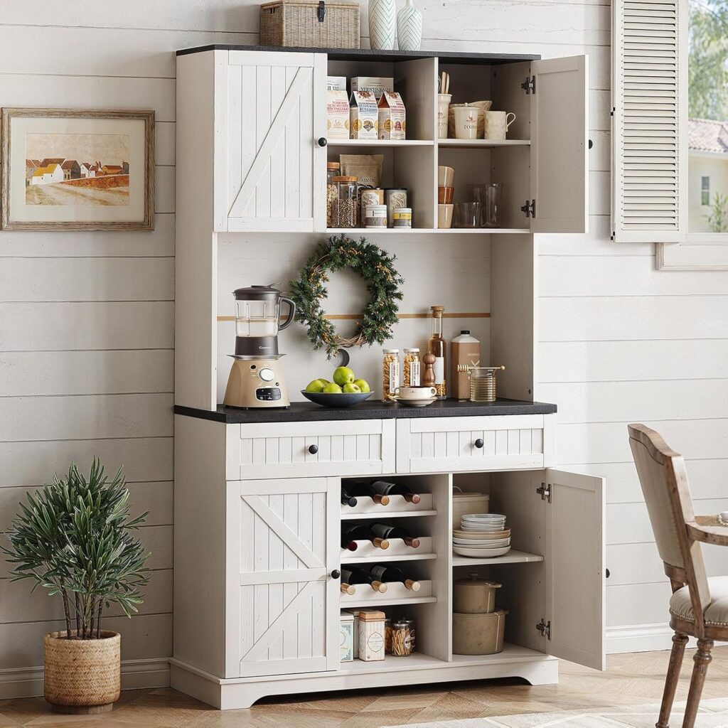 A white farmhouse freestanding pantry sits against white shiplap walls. It has multiple shelves above and below the black built-in counter.
