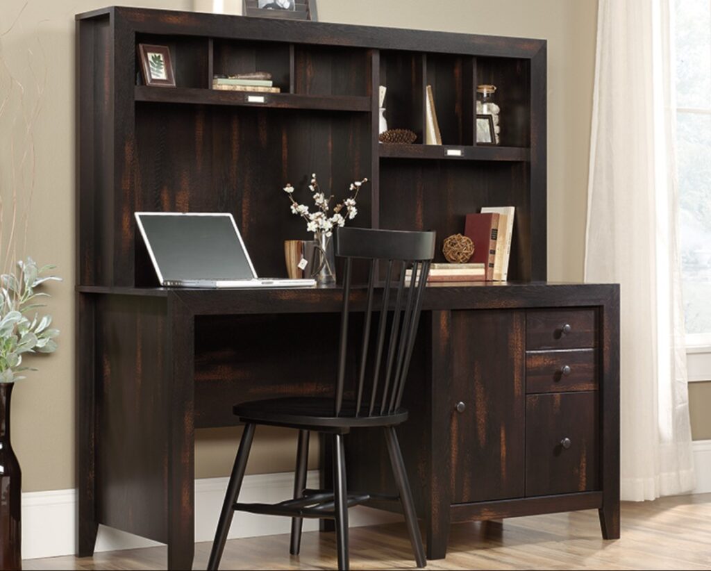 a dark, painted wooden computer desk workspace
