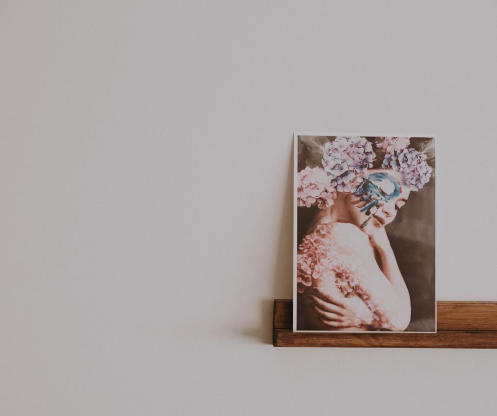 a modern photograph resting on a wooden shelf