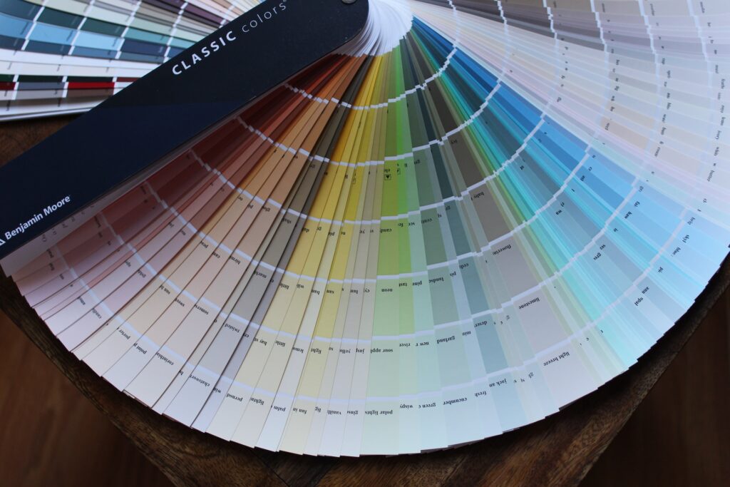 a splayed out fan of multicolored paint samples to match paint colors with accuracy
