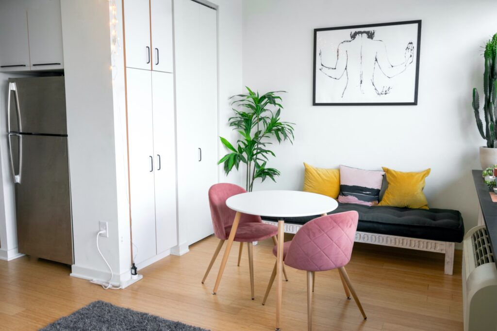 a smalla cute breakfast nook table with a comfy bencg