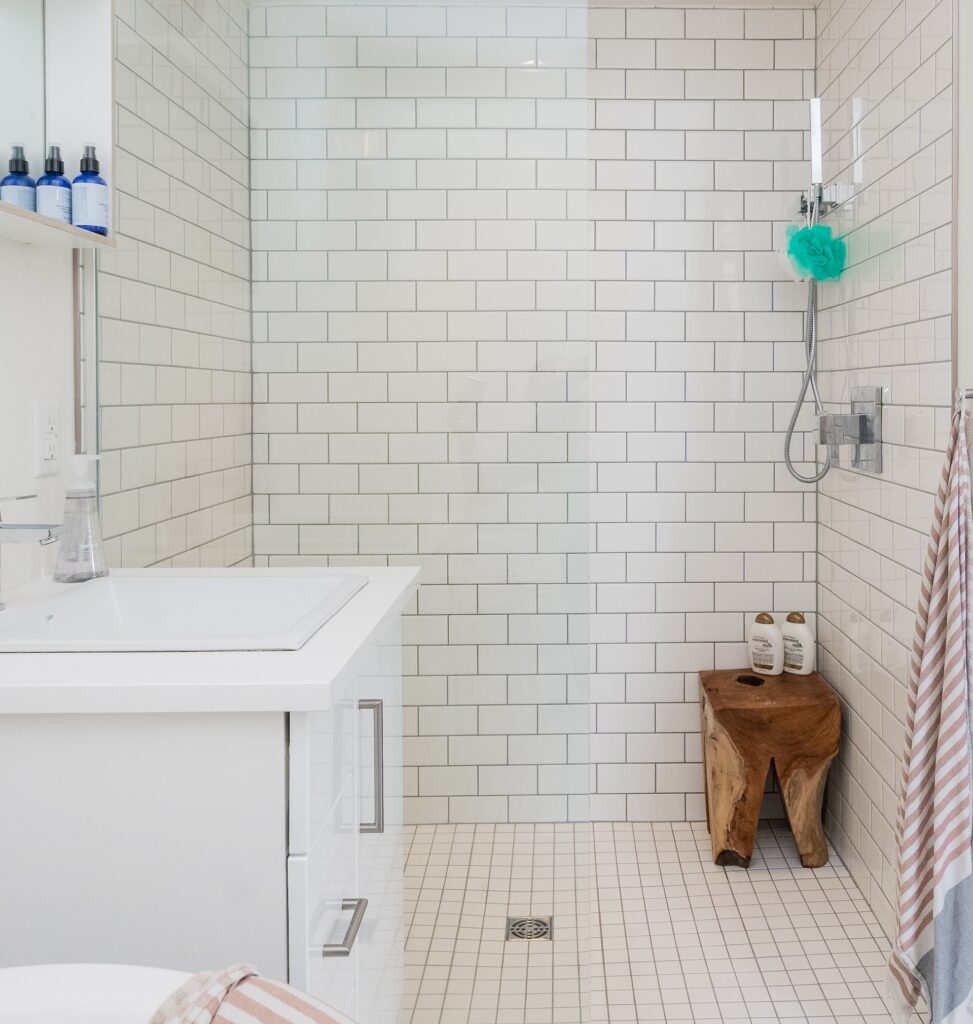 an open white tiled shower stall