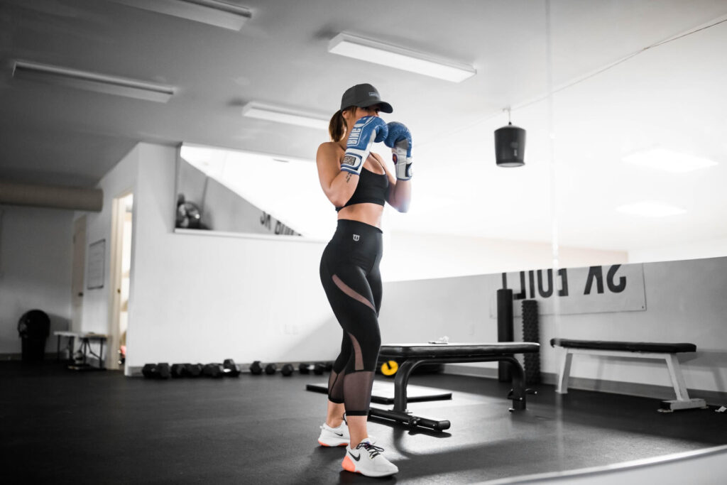 Woman training in boxing in an orthodox stance.