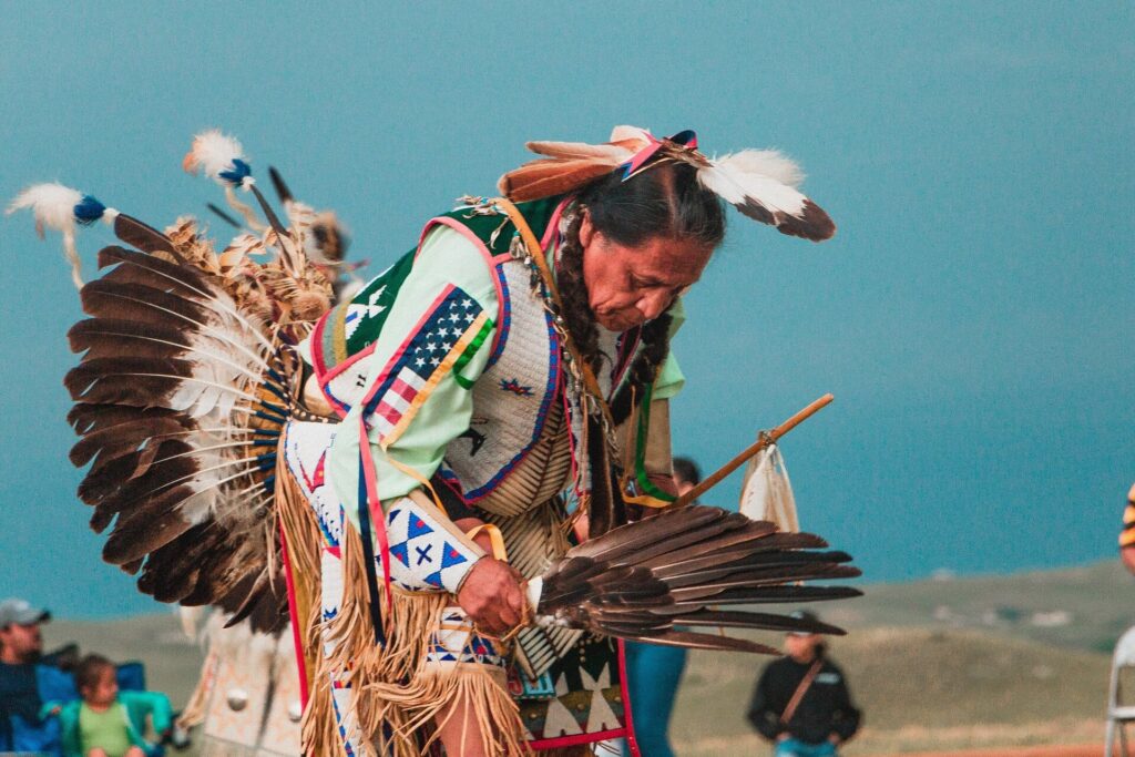 A native American man wearing a traditional outfit.