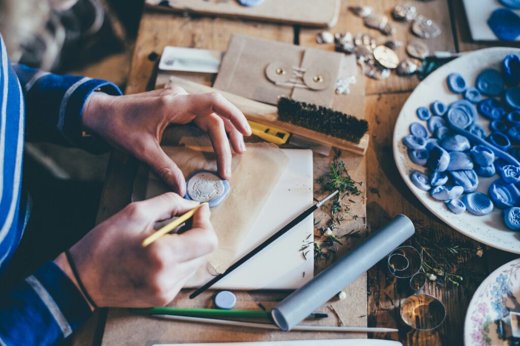 Person making handcrafted goods in a workshop.