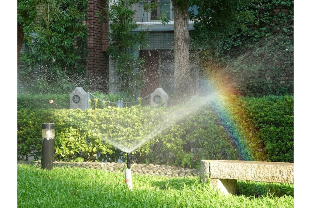 Water conservation techniques include sprinklers connected to greywater systems.