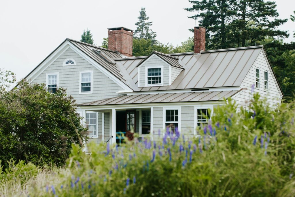 A house behind green plants