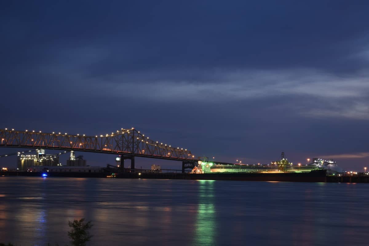 a lit bridge over a river at night inBaton Rouge, LA