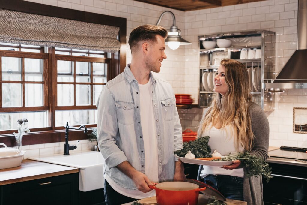 A man and woman cooking dinner in the kitchen