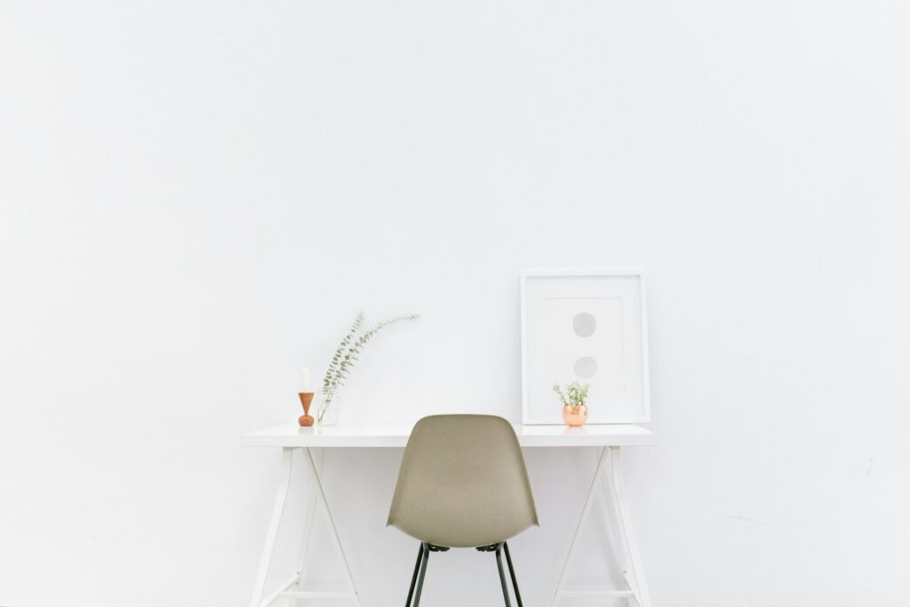 A white wooden table with a brown chair