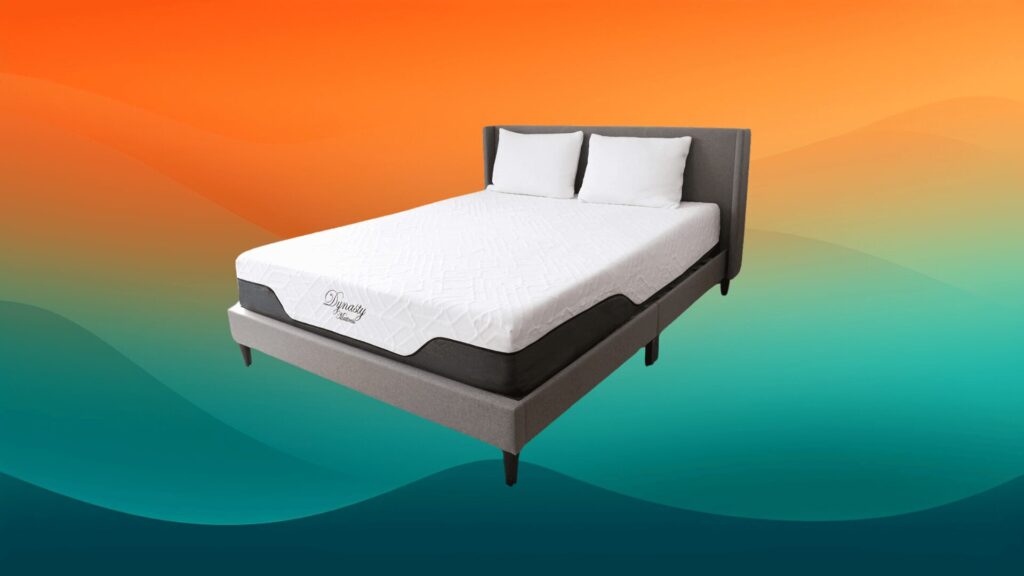 gray and white mattress on a gray bed frame in front of an orange and teal background