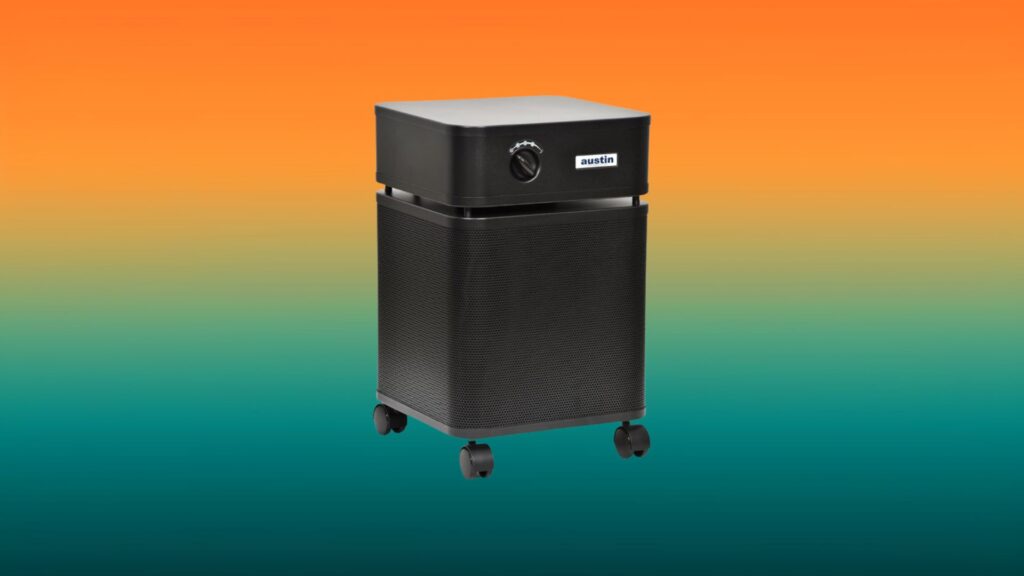 black Austin Air Healthmate Plus air purifier with an orange and teal gradient background