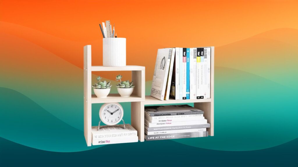 white cube tabletop cheap bookcase with books and decor on top in front of an orange and teal background