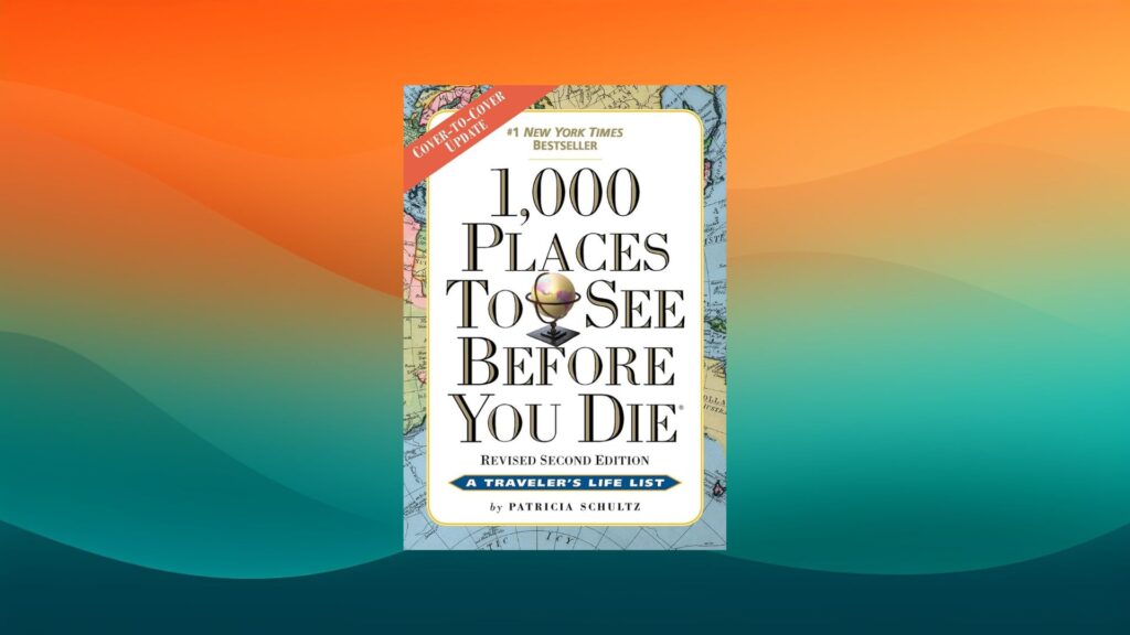 1000 Places to See Before You Die coffee table book in front of an orange and teal background