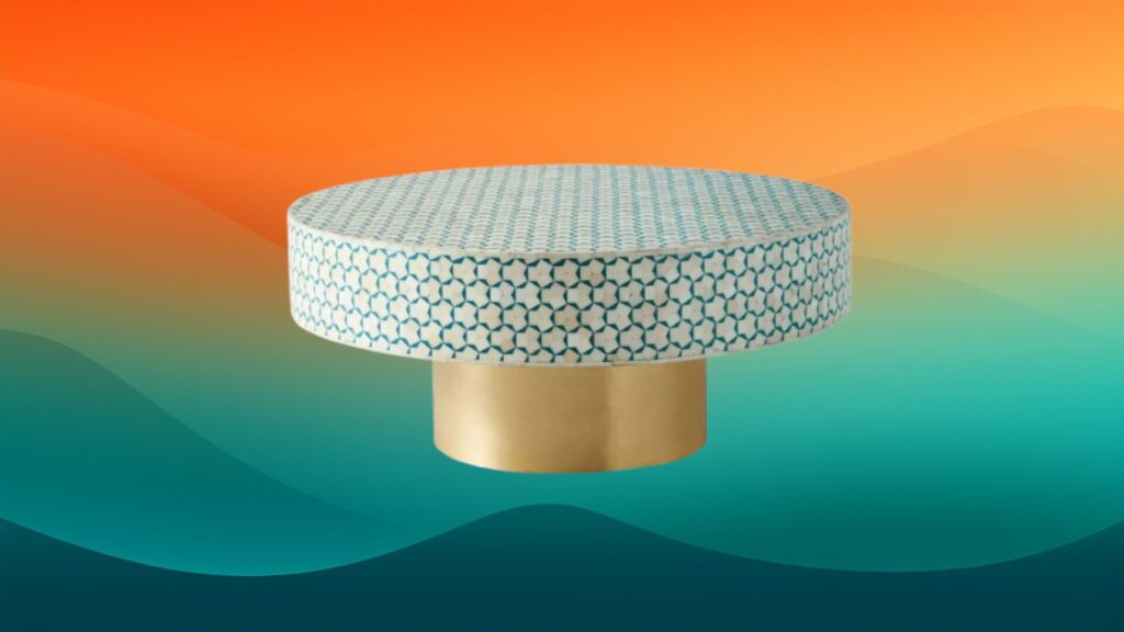 Moroccan inspired coffee table with white and teal circular tiles and a gold base in front of an orange and teal gradient background