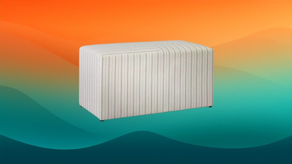 cloth striped ottoman style coffee table in front of an orange and teal gradient background