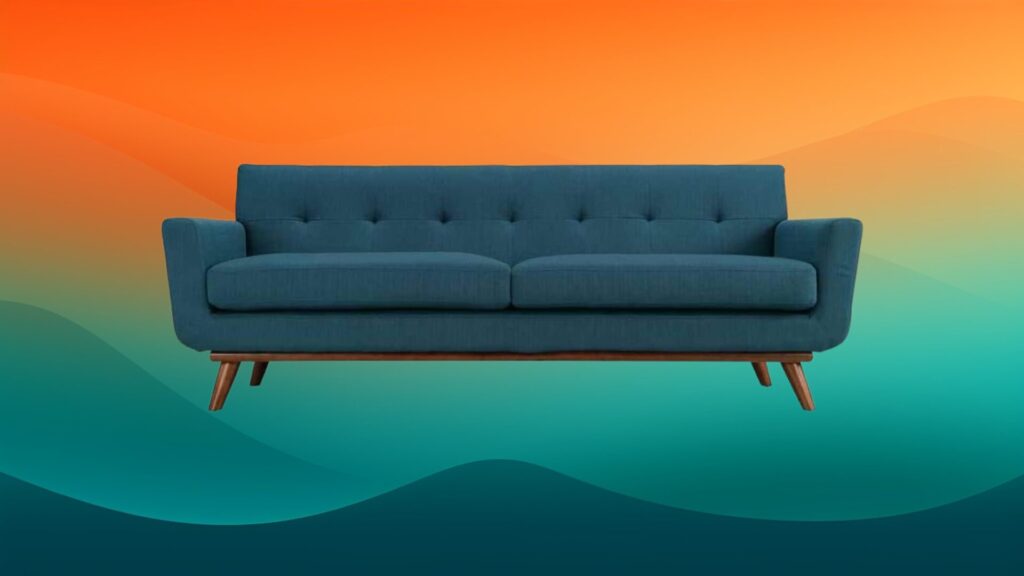azure tufted couch in front of an orange and teal background