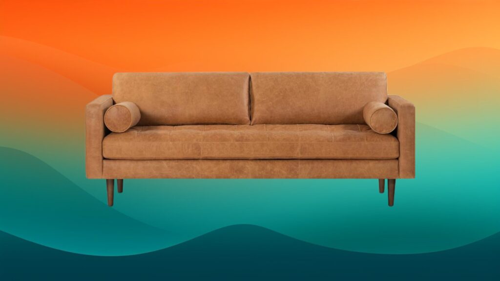 leather couch in front of an orange and teal background