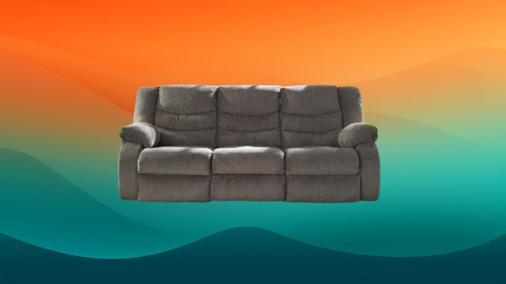 gray reclining sofa in front of an orange and teal background