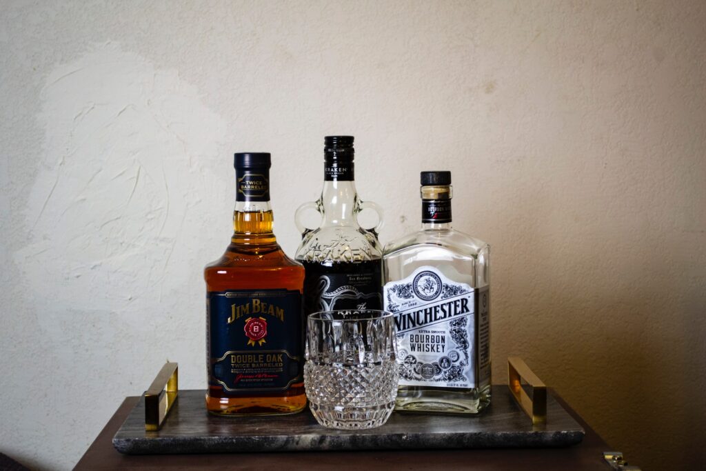 Three bottles of liquors on a small tray as a mini bar for a party