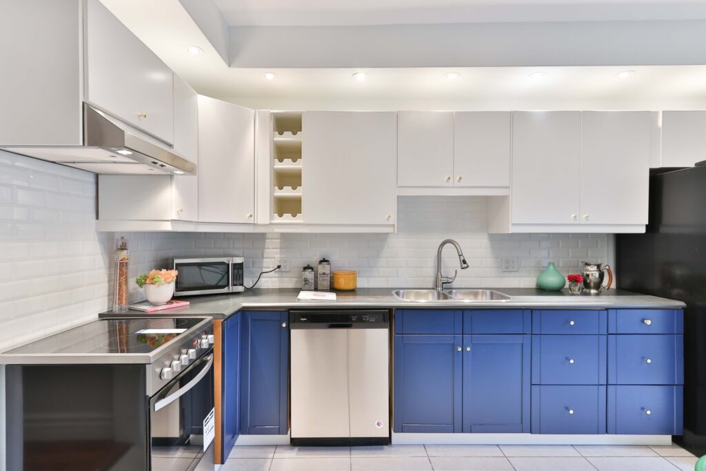 a clean kitchen with blue lower cabinets