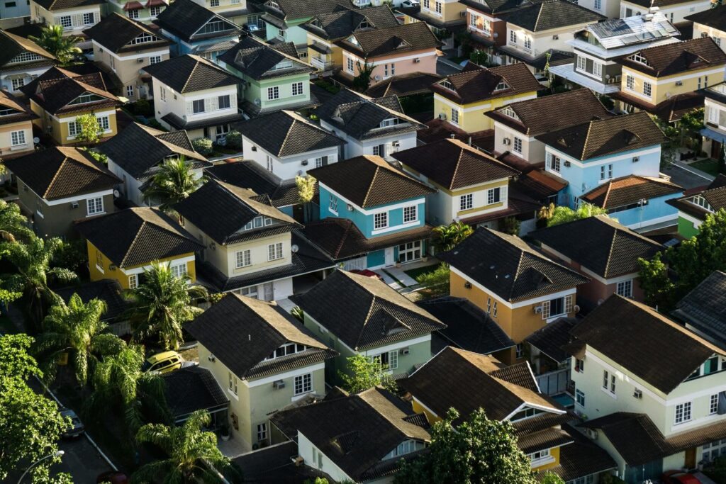 A bird's eye view of a neighborhood with identical houses of various colors.