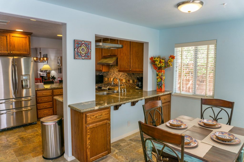 A dining room and kitchen with icy light blue walls