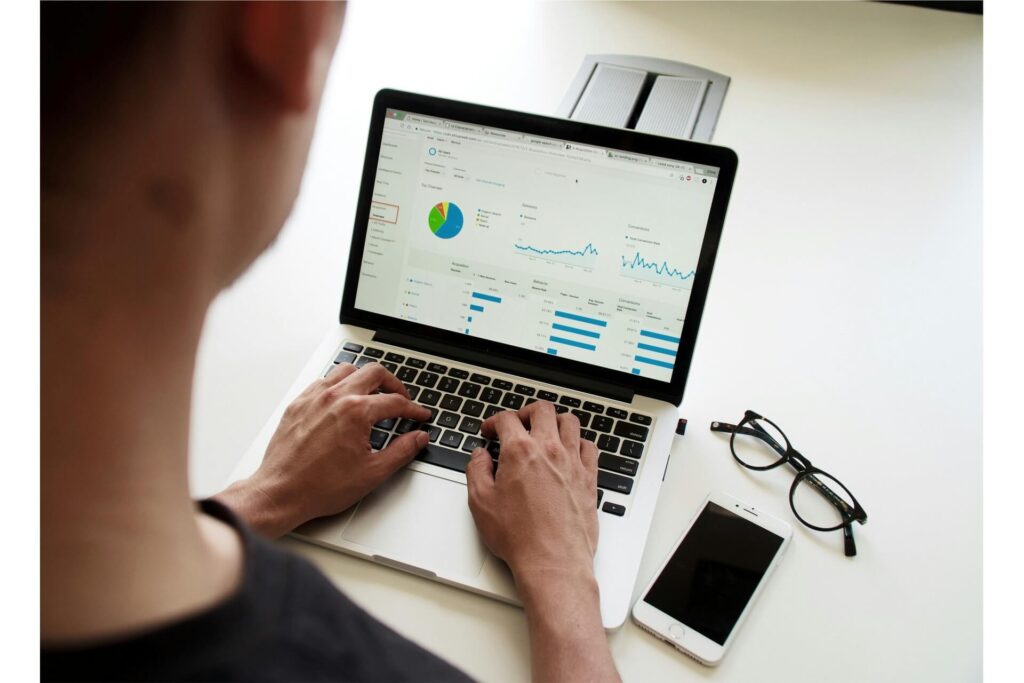 A person doing reports on a laptop.
