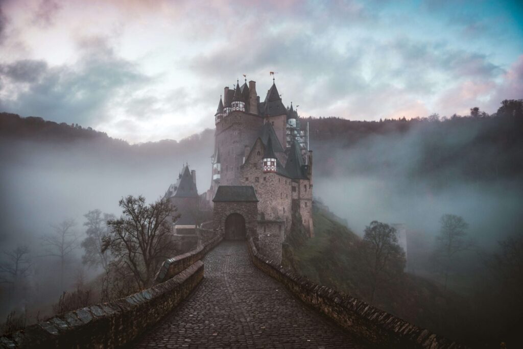 A mansion on the top of a misty hill