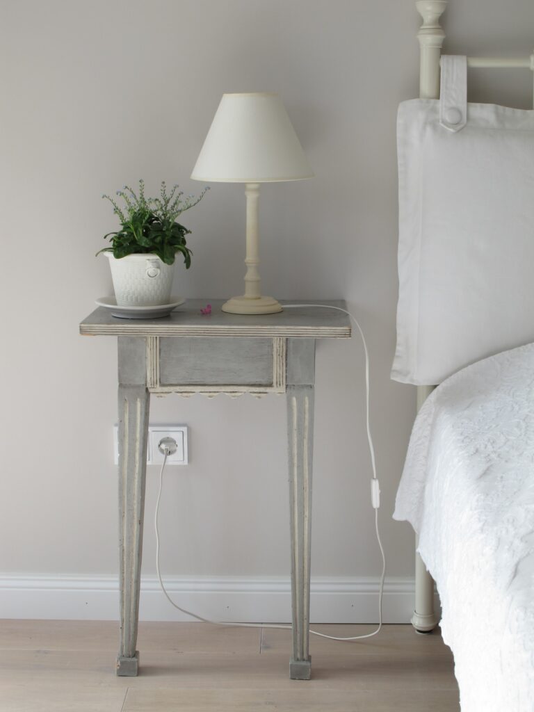 a white bedroom with white bedding