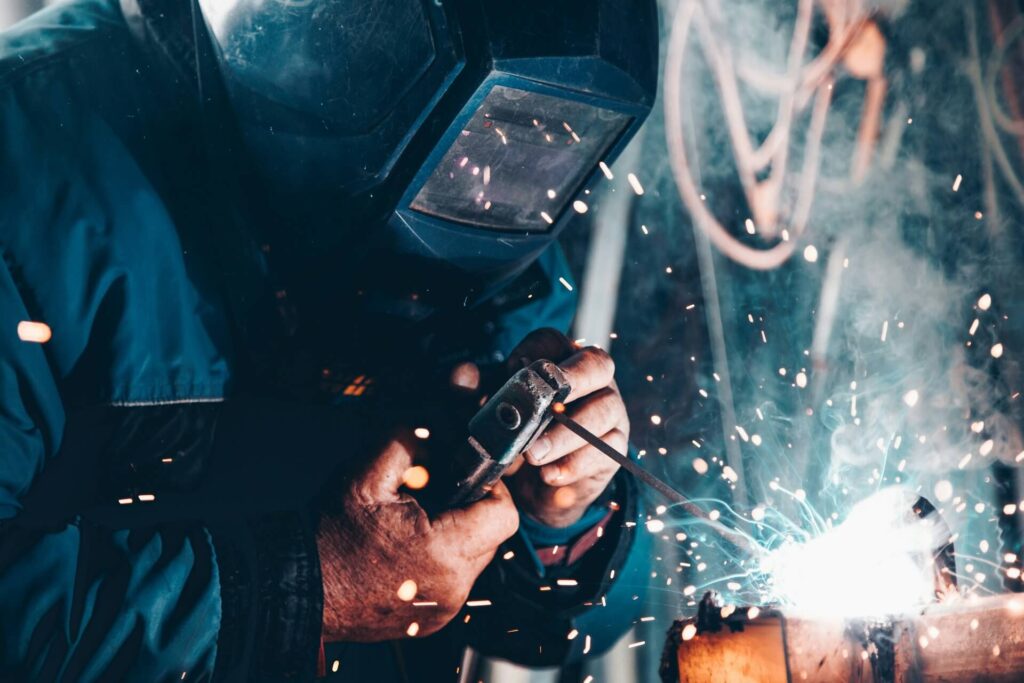 Protective equipment includes face shields and heavy-duty clothes for construction.