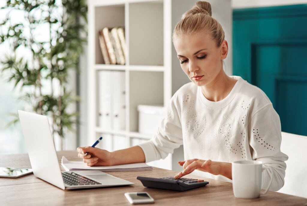 a woman with a laptop and calculator