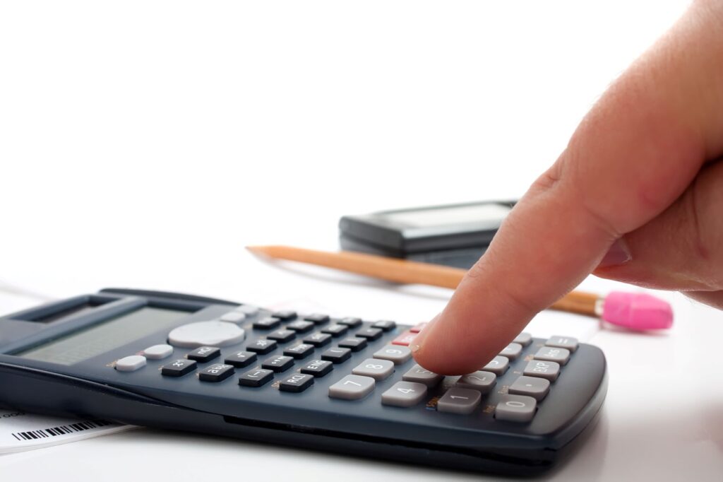 finger on black calculator