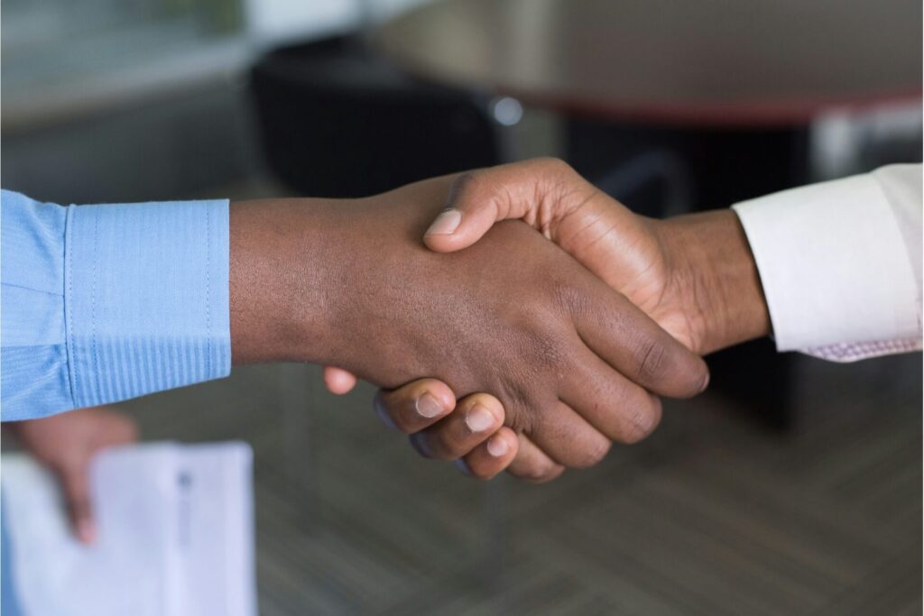 Two persons shaking hands.