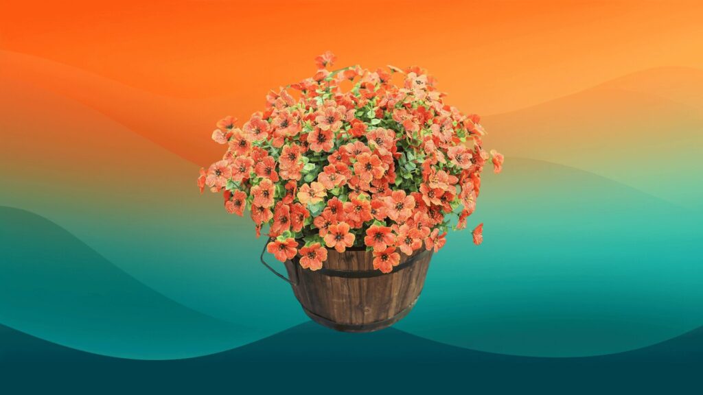 orange faux mum flowers in a wooden basket to decorate your porch for fall in front of an orange and teal background