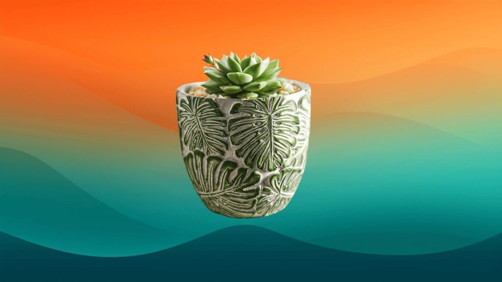small gray decorative indoor flower pot with monstera leaves on it in front of an orange and teal background