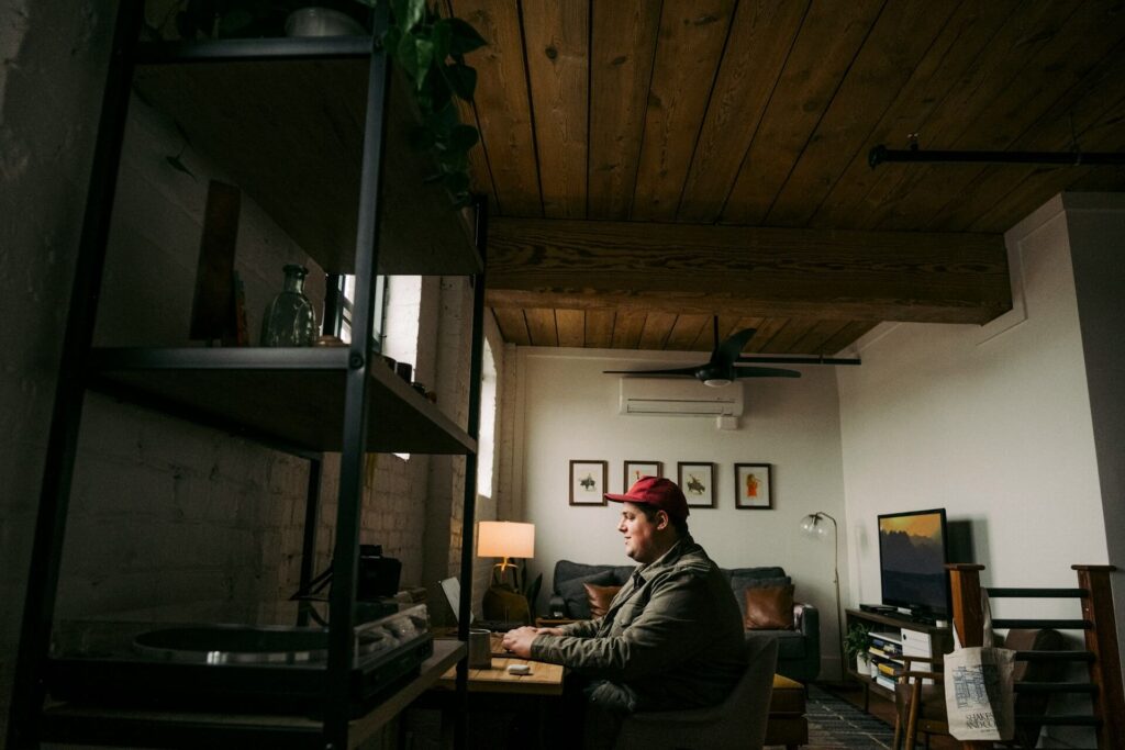 A man in front of a computer at home