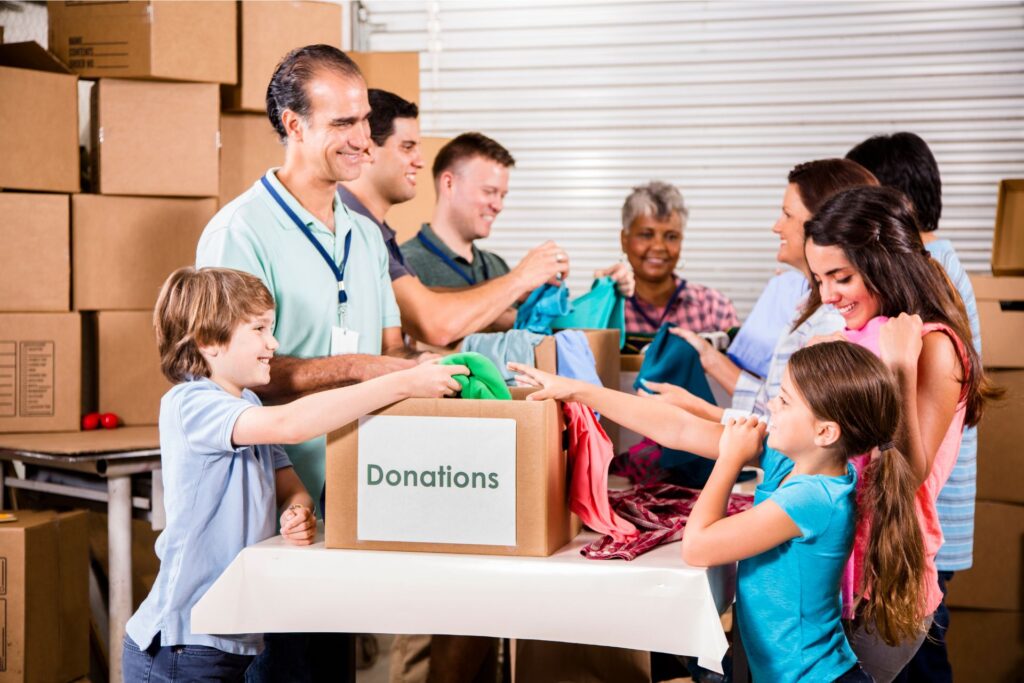 Group of people donating items to charity.
