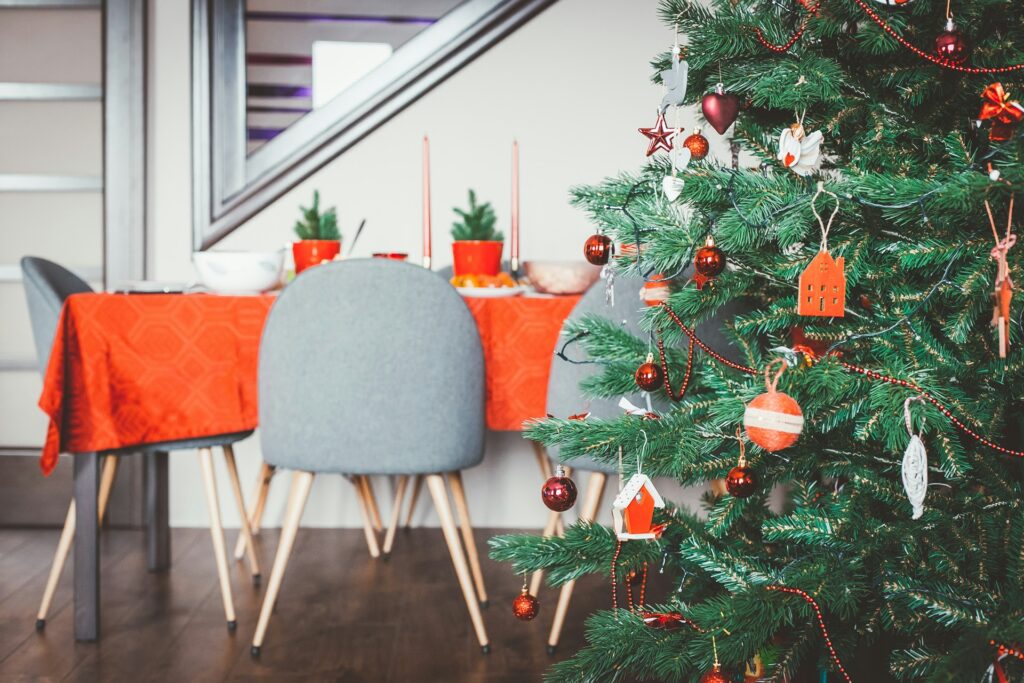 how to put Christmas lights on a tree - A dinner table with good beside a beautiful tree