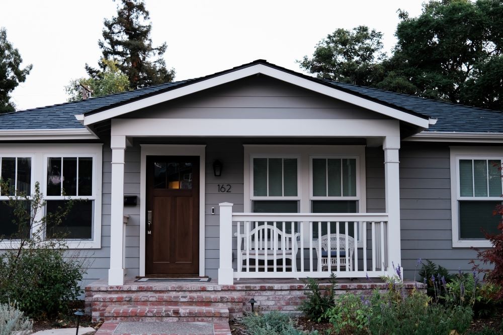 beautiful front door renovation on ranch style house with front porch