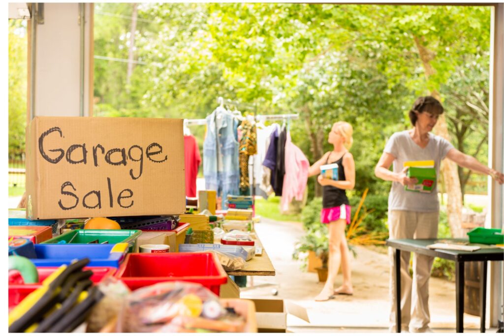 Layout for a garage sale. Items on tables. People browsing.