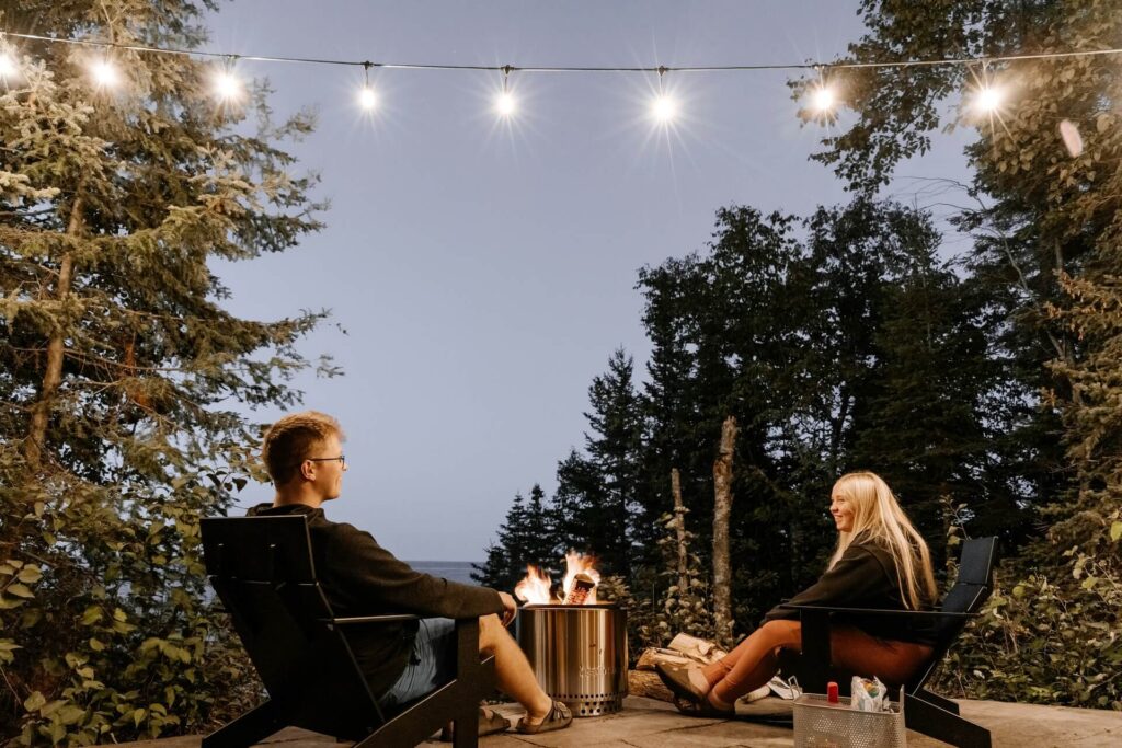 A couple enjoying their backyard fire pit.