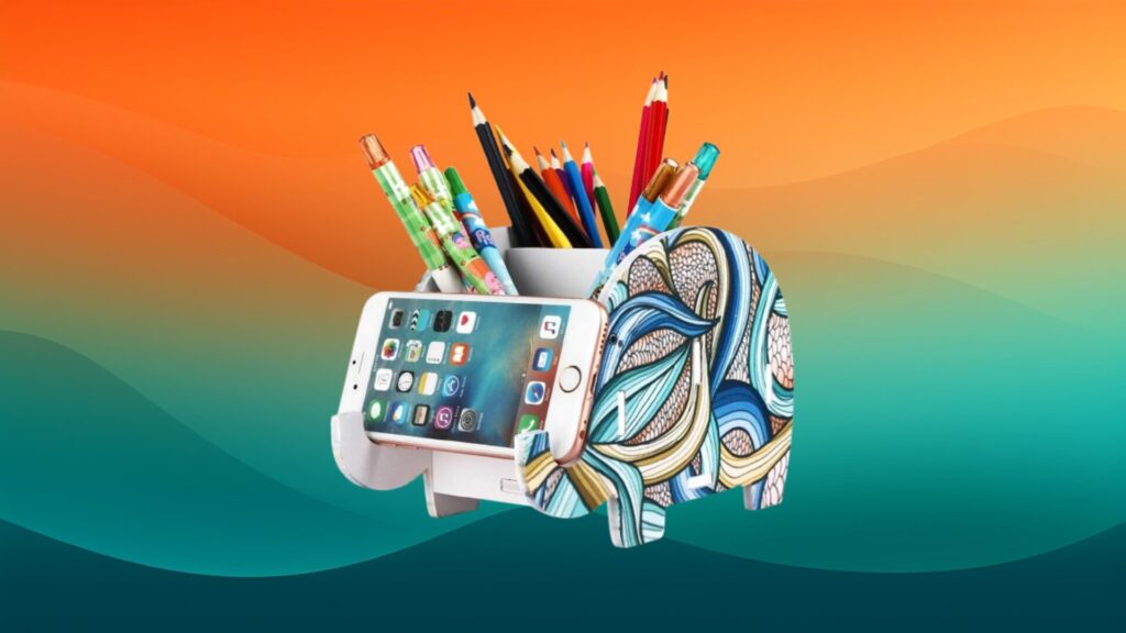 home office organizer elephant shaped pencil and phone holder in front of an orange and teal gradient background