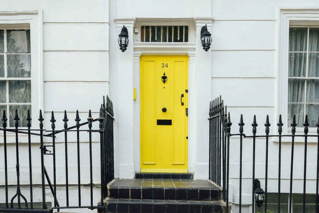 white house with bright yellow front door